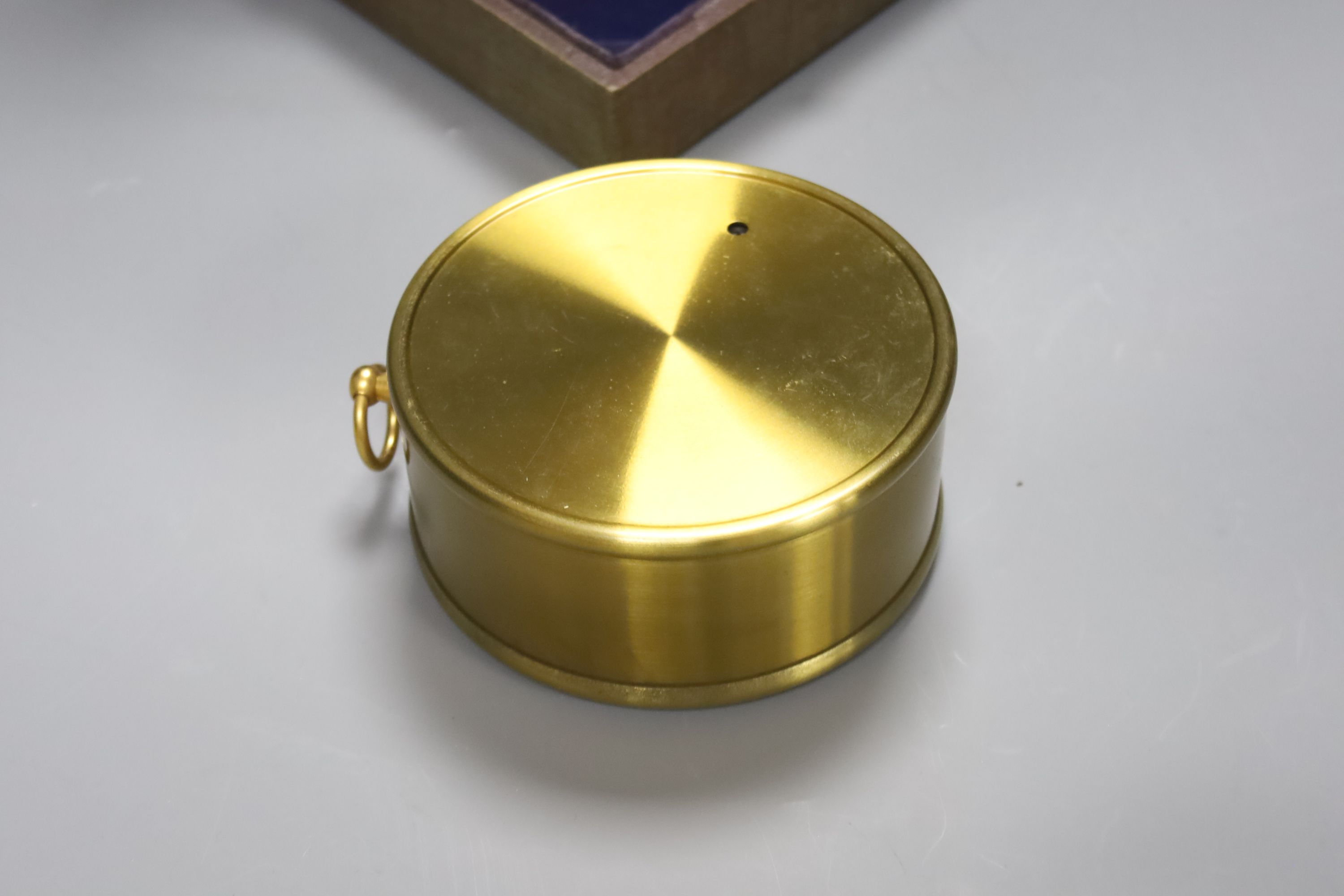 A cased Negretti & Zambra brass cased barometer, diameter 12cm